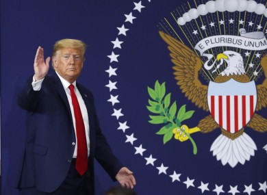 President Donald Trump waves after speaking about the USMCA trade deal at a Dana plant in Warren, Michigan.
