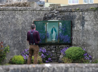 Author John Pascal Rodgers on the grounds of an unmarked grave containing the remains of the babies who died in Tuam mother and baby homes.