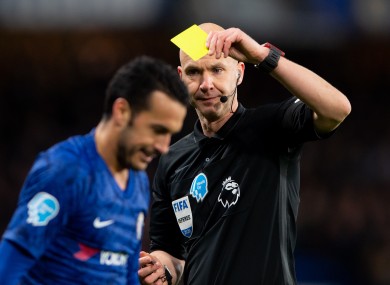 Referee Anthony Taylor booking Chelsea's Pedro during a Premier League game against Man United in February.