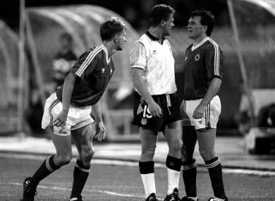 Ray Houghton and Paul Gascoigne square up at Italia '90, with Chris Morris watching on.