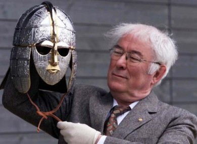 Seamus Heaney holding a replica saxon helmet in 2002.