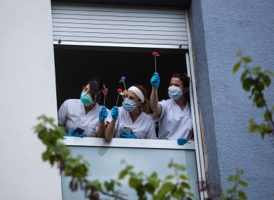 Nurses hold roses on Sant Jordi's day.