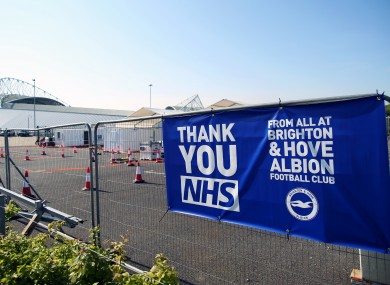 A 'Thank You NHS' banner from Brighton & Hove Albion Football Club is displayed near the entrance of the drive-in coronavirus testing centre at the Amex Stadium.