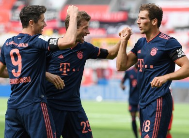 Lewandowski (left) celebrates with Thomas Muller and Leon Goretzka (right.)