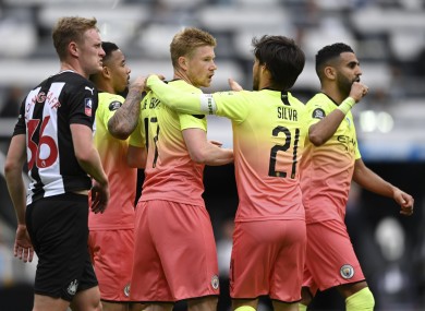 Man City celebrate De Bruyne's opener at St James' Park.