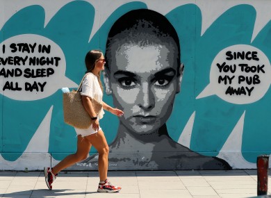 A woman walks past Irish artist Emmalene Blake's mural of singer Sinead O'Connor near the site of the old Bernard Shaw pub in Dublin.