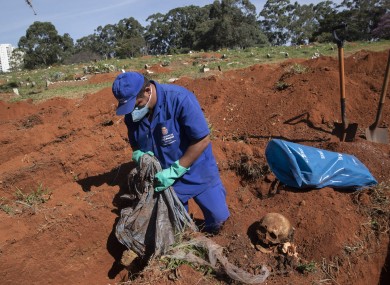 Cemetery workers exhume remains buried three years ago at the Vila Formosa cemetery, which does not charge families for the gravesites, in Sao Paulo, Brazil, yesterday.