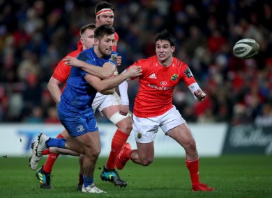 Ross Byrne with Munster's Joey Carbery in a Pro14 clash at Thomond Park last year.