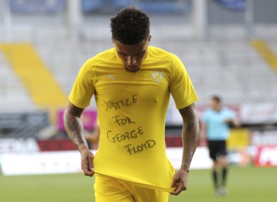 Jadon Sancho of Borussia Dortmund celebrates scoring with a 'Justice for George Floyd' shirt.