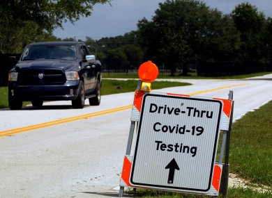 A sign directs people to a drive through COVID-19 testing site operated by the Florida Department of Health.