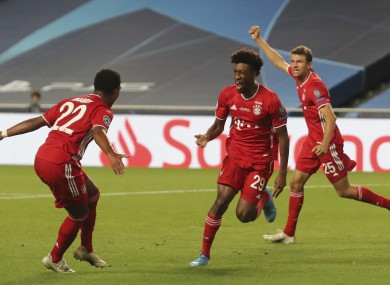 Bayern's Kingsley Coman, centre, celebrates with teammate Thomas Mueller, right, and Serge Gnabry