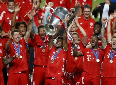 Bayern's Kingsley Coman lifts the trophy after Munich won the Champions League.