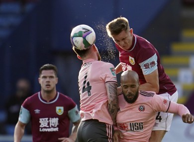 Jimmy Dunne of Burnley wins an aerial battle with Sheffield United's Oliver Burke and David McGoldrick.