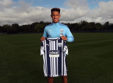 Robinson holding up the Baggies shirt.
