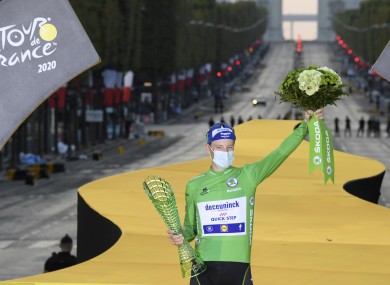 Sam Bennett of Ireland, wearing the best sprinter's green jersey, celebrates on the podium in Paris.