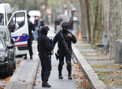 Riot police officers arrive after four people were wounded in a knife attack near the former offices of Charlie Hebdo magazine