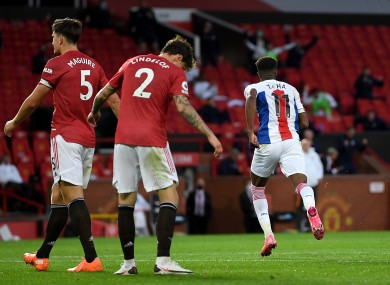 Zaha celebrates scoring his side's third goal at Old Trafford.