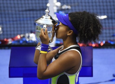 Naomi Osaka kisses the trophy.