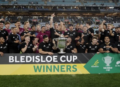 New Zealand captain Sam Cane, centre, celebrates with his teammates with the Bledisloe Cup.