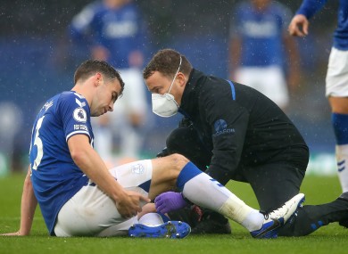 Everton's Seamus Coleman (left) receives treatment for an injury before being substituted.