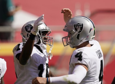 Las Vegas Raiders wide receiver Nelson Agholor (left) celebrates with quarterback Derek Carr.