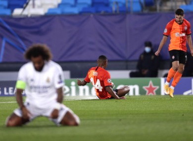 Real Madrid's Marcelo is dejected as Tete celebrates after opening the scoring for Shakhtar Donetsk.
