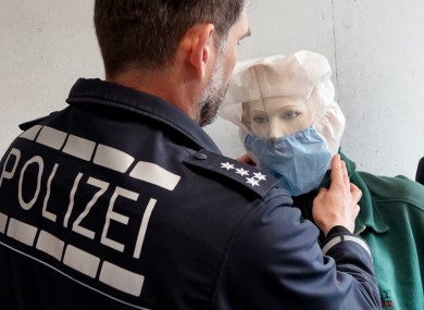 A police officer in the German city of Heilbronn in northern Baden-Württemberg puts an anti-spit hood on a mannequin.
