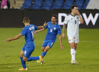 Shon Weissman and Dia Seba celebrate after Israel's goal as Scotland's Ryan Jack looks dejected.