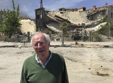 Robert Fisk stands in front of a destroyed building in the Damascus suburb of Douma, April 2018.