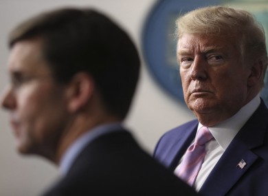 President Donald Trump listens to Defense Secretary Mark Esper