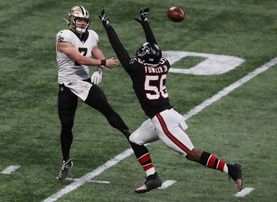 Taysom Hill gets off a pass under pressure from Atlanta Falcons defensive end Dante Fowler.