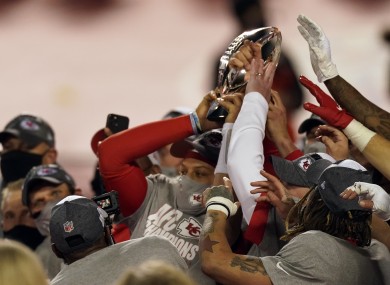 Kansas City Chiefs quarterback Patrick Mahomes, left, celebrates with the Lamar Hunt Trophy.