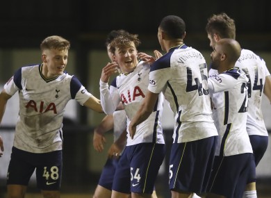 Teammates celebrate with Tottenham's Alfie Devine.