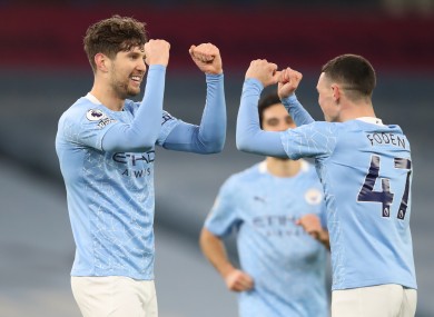 Manchester City's John Stones (left) celebrates scoring his side's third goal of the game with team-mate Phil Foden.
