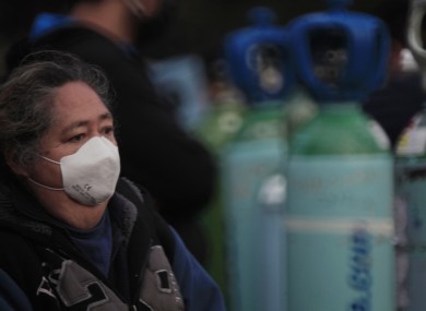 A person waits in line to be able to refill an oxygen tank, Mexico City.