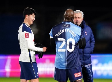 Wycombe Wanderers' Adebayo Akinfenwa in discussion with Tottenham Hotspur's Son Heung-min (left) and manager Jose Mourinho (right).