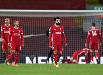 Liverpool players show their disappointment after conceding.