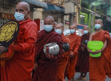 Buddhist monks asking for alms in Yangon, Myanmar, today.