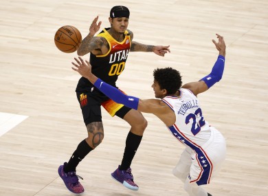 Utah Jazz guard Jordan Clarkson and Philadelphia 76ers guard Matisse Thybulle battle for the ball.