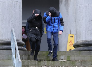 Patrick O'Brien (right) covers up as he leaves Tralee District Court.