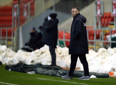 Wayne Rooney watching on.