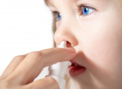 File photo of a child using nasal spray