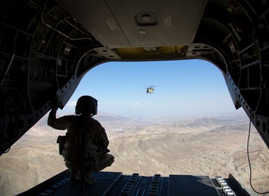 A soldier form the US 101st Airbone looks out at the partner Chinook following during a resupply mission in Jalalabad. October 2018.