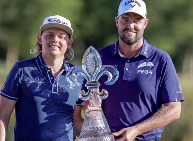 Cameron Smith and Marc Leishman hold up the Zurich Classic trophy and belts after winning the final round round of the Zurich Classic of New Orleans golf tournament.