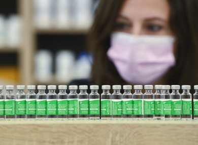 Canadian pharmacist Barbara Violo arranges empty vials of the Oxford-AstraZeneca Covid-19 vaccines that she has provided to customers.