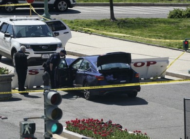 US Capitol Police examine the car that crashed into the barrier