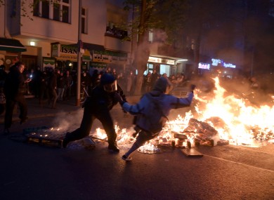 Police and participants clash during a fire at the edge of the demonstration in Berlin.