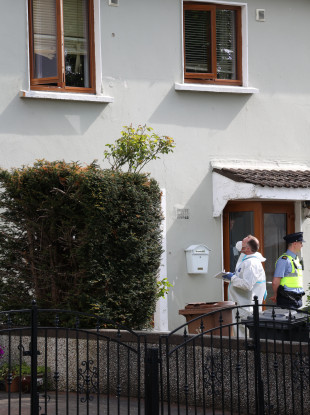 Gardai forensic teams (Technical Bureau) look at the bullet holes in the windows at the scene of a shooting and siege at Whitechapel Grove, Blanchardstown.