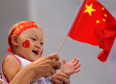 A child waves the Chinese flag during the Olympic Games in Beijing. 10 August 2008.