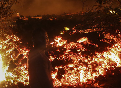 A person stands in front of lava from the eruption of Mount Nyiragongo, in Buhene.